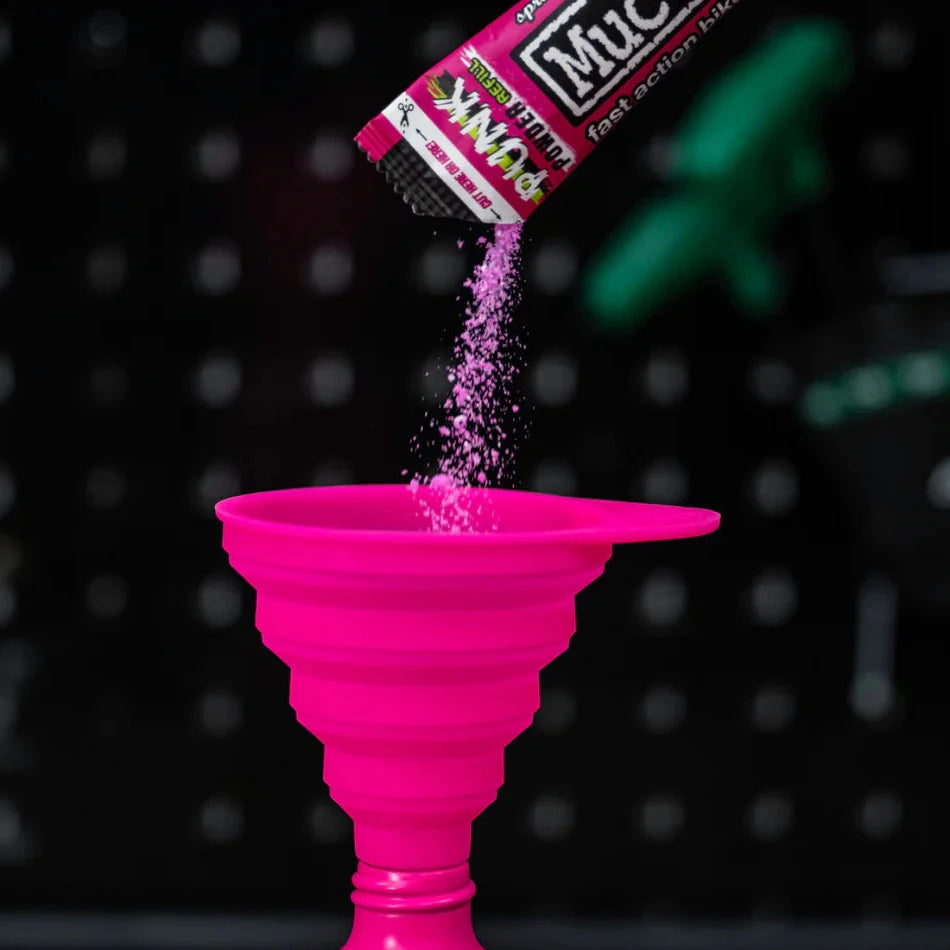Muc-Off pink Collapsible Silicone Funnel used for refilling cleaning powder