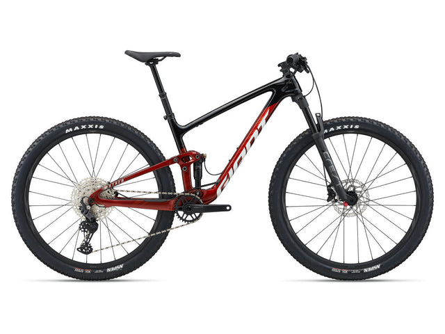 A red and black Giant Anthem Advanced 29 mountain bike with a rear suspension and dual chainrings.