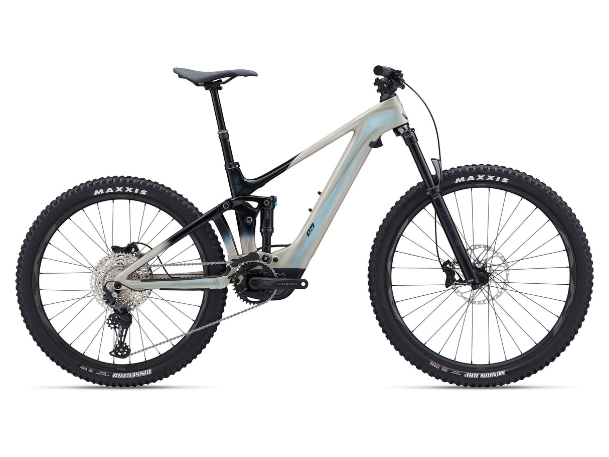A Liv Intrigue X Advanced E+ EL 3 electric mountain bike with a light blue frame and black accents, featuring a front suspension fork, rear suspension, and a chain drive system.