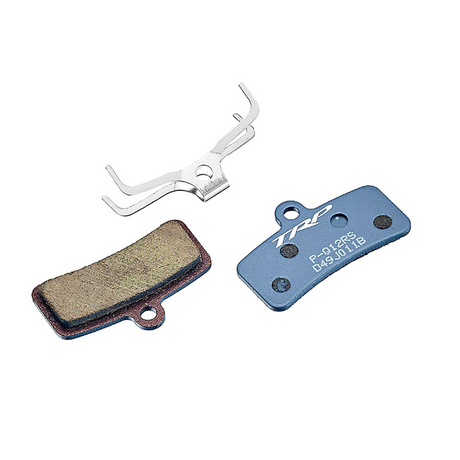 Brake pads and a tool on a white background