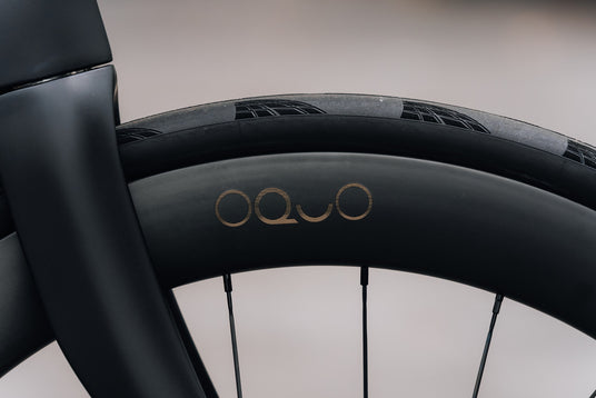 OQUO wheel logo in gold